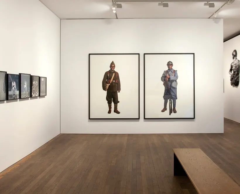 Colour photograph of Gallery interior with large framed portrait photographs on the wall